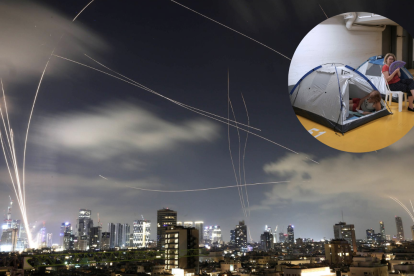 Residentes de Tel Aviv corren hacia refugios tras activarse una alarma antiaérea por misiles iraníes