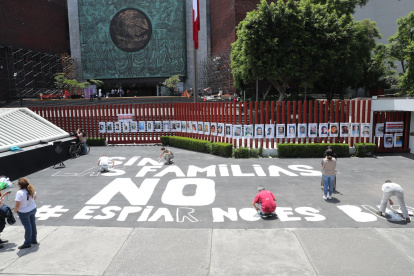 Familiares y colectivos de personas desaparecidas colocan carteles con fotografías durante una protesta en la Ciudad de México (México).