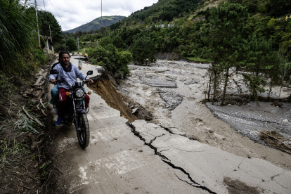 La gente circula por la carretera Trasandina parcialmente destruida tras la inundación del río Chama, cerca de Mérida, el 25 de junio de 2025, tras fuertes lluvias en la zona.