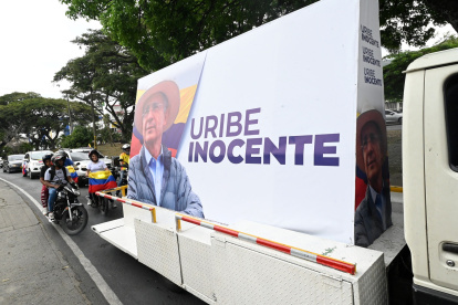 Supporters of former Colombian President Alvaro Uribe participate in a caravan in Cali, Colombia, on July 28, 2025. The influential former Colombian president Alvaro Uribe will learn the verdict in his trial on Monday for alleged witness tampering and fraud, a historic case linked to paramilitarism that has brought a former head of state to the dock for the first time. (Photo by JOAQUIN SARMIENTO / AFP)