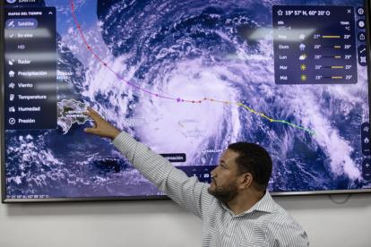 El predictor de la Oficina Nacional de Meteorología, Wagner Rivera, señala una pantalla este sábado, en Santo Domingo (República Dominicana). El huracán Erin se intensificó rápidamente hasta convertirse en un "catastrófico" categoría 5, la máxima en la escala Saffir-Simpson, con vientos máximos sostenidos cercanos a los 260 kilómetros por hora mientras avanza por el Atlántico, informó el Centro Nacional de Huracanes (NHC, en inglés) de EE.UU. EFE/ Orlando Barría