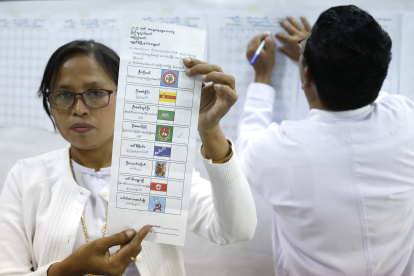 Funcionarios electorales de Myanmar cuentan las papeletas de votación en la primera fase de las elecciones generales en la capital de Myanmar, el 28 de diciembre de 2025.