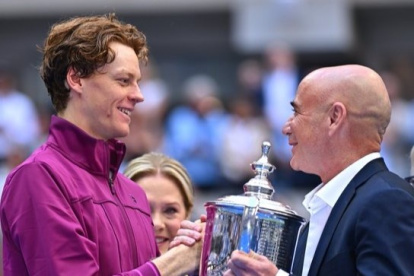 Jannik Sinner (I) recibiendo un premio de la leyenda, Andre Agassi (D).