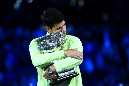 El español Carlos Alcaraz abraza el trofeo del Abierto de Australia que con 22 años y 272 días, es el más joven en lograrlo.