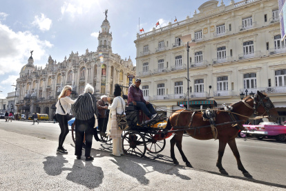 Fotografía del 29 de enero de 2026 que muestra a turistas montando en un coche alado por un caballo en La Habana (Cuba).