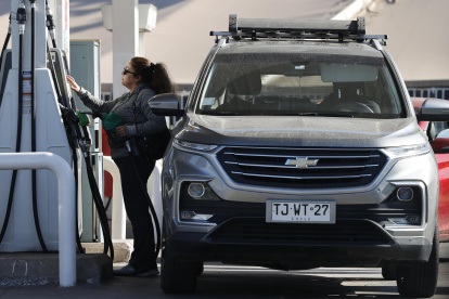 Una persona abastece de combustible un vehículo en una estación de servicio este martes, en Santiago (Chile).