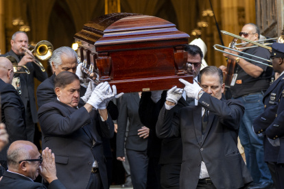 Personas sostienen el féretro del cantante Willie Colón este lunes, al finalizar una misa pública con motivo de su funeral en la Catedral de San Patricio en Nueva York.