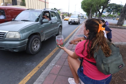 Una mujer vende caramelos en la calle en Guayaquil.