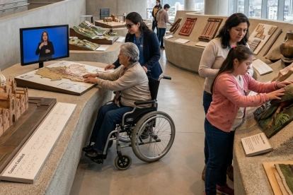 Una persona que utiliza silla de ruedas interactúa con una maqueta táctil de una catedral en un museo moderno y luminoso