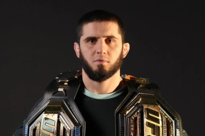 Islam Makhachev posa con los cinturones de campeón de Peso Ligero y Peso Welter de la UFC.