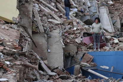 Residentes caminan entre los escombros de edificios derrumbados tras los terremotos en Catia La Mar, estado La Guaira.