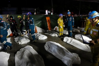 Los equipos de rescate recuperan los cuerpos de las víctimas del incendio ocurrido en un pub en Bangkok.