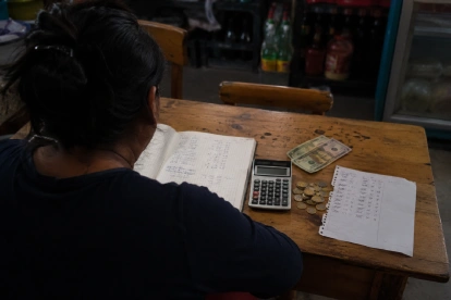 Una mujer revisa sus cuentas ante la falta de crédito formal, una situación que empuja a miles de ecuatorianos hacia préstamos del chulco. Imagen referencial.