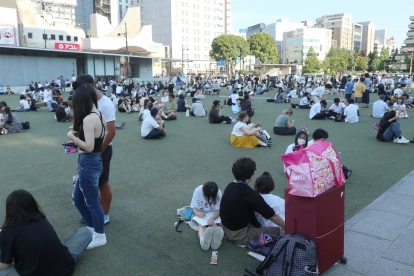 Varias personas se congregan frente a un edificio tras un potente terremoto en la ciudad de Kumamoto, Japón, el 28 de julio de 2026.