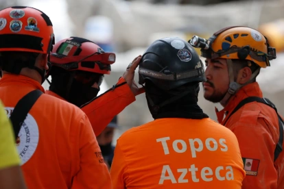 Integrantes de una brigada de Los Topos Aztecas mexicanos habla este miércoles, durante una jornada de búsqueda y rescate en Cali (Colombia).