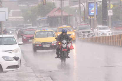Lluvia en el norte de Guayaquil. Motociclistas usan vestimenta para protegerse.