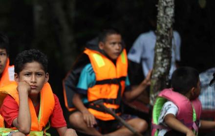 Grupo de niños en canoas por el rio Itaya, en Iquitos (Perú).
