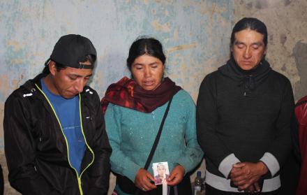 Portando una foto de Luis Quezada, familiares oran por su alma.