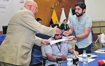 Guayas. Julio Candell (d), director de Procesos Electorales, entrega reportes del sorteo al notario Carlos Alvear.