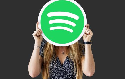 woman-holding-up-spotify-icon-isolated (1)