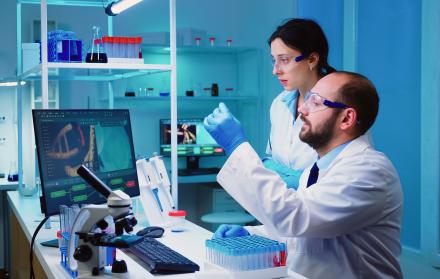 chemist-nurse-holding-test-tubes-bringing-to-doctor-conducting-dna-experiment-discussing-about-medical-treatment-working-overtime