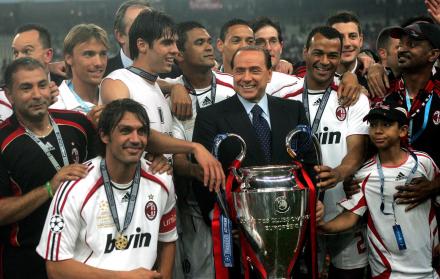 Silvio Berlusconi, presidente del AC Milán, sostiene junto a sus jugadores el trofeo de campeones