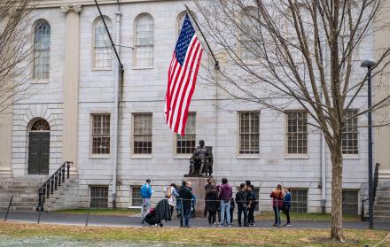 Las personas se reúnen alrededor de la estatua de John Harvard en el campus de la Universidad de Harvard en Cambridge, Massachusetts, el 15 de abril de 2025.