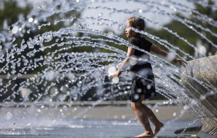 Una niña se refresca en una fuente de agua en Georgetown Waterfront Park en Washington (Estados Unidos).