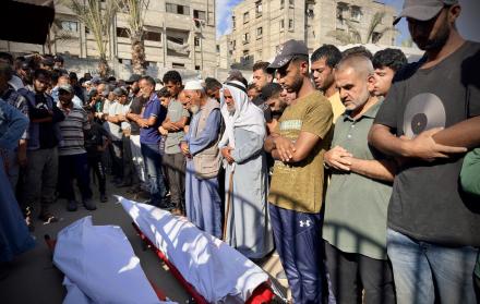 Personas rezan tras la llegada de muertos en Gaza