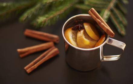 beber-vino-caliente-sobre-mesa-negra-con-ramas-de-pino