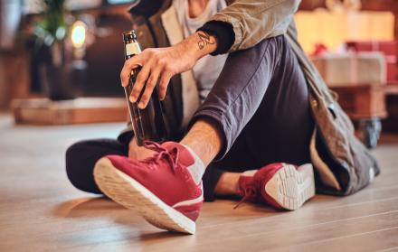 attractive-bearded-indian-male-drinks-craft-beer-room-with-christmas-decoration