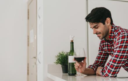 cheerful-man-having-wine-home