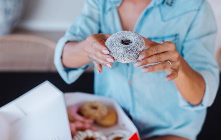 portrait-european-woman-with-blonde-hair-enjoying-donuts-kitchen-home-villa
