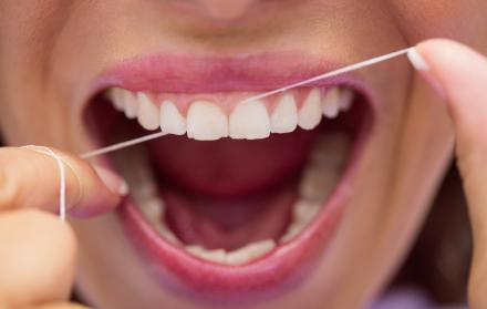 female-patient-flossing-her-teeth