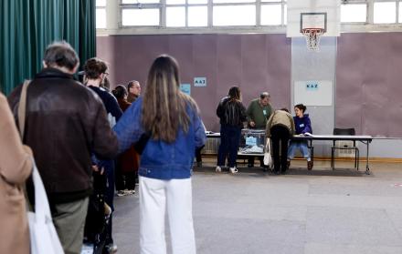 Personas hacen cola para votar en un colegio electoral