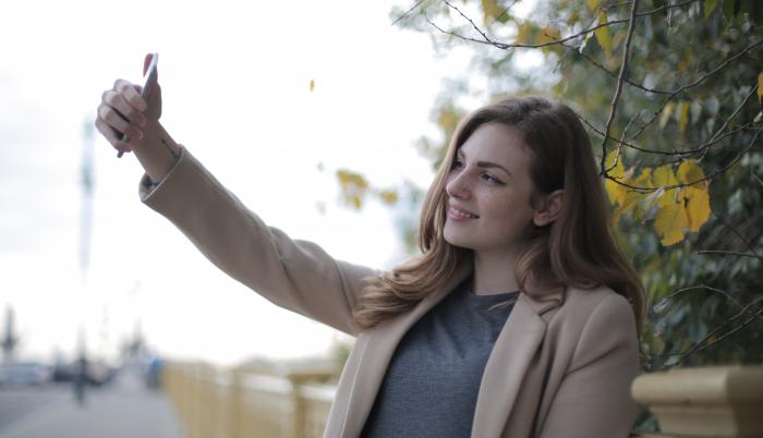 young-woman-in-coat-taking-selfie-with-smartphone-on-street-3776445