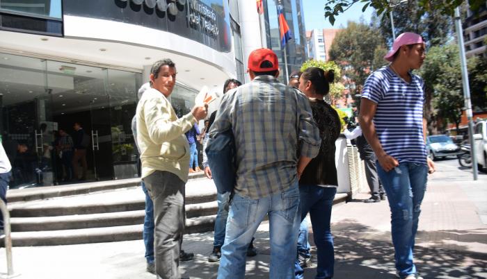 En los exteriores del Ministerio de Trabajo, un grupo de personas dialoga sobre el salario.