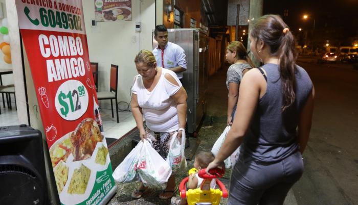Guayaquil. Después de hacer sus compras, una numerosa familia se prepara para merendar.
