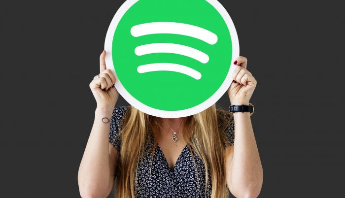woman-holding-up-spotify-icon-isolated (1)