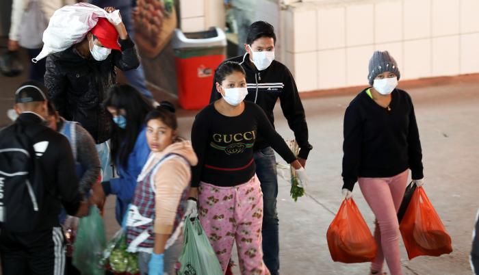 Ciudadanos ecuatorianos se acercan con mascarillas al Mercado de San Roque en el Centro Histórico de Quito (Ecuador), en una fotografía de archivo.