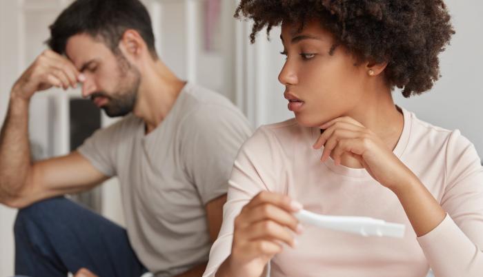 shot-of-pleasant-looking-black-woman-holds-pregnancy-test-with-negative-result