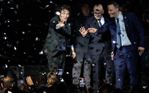 El presidente Javier Milei, saluda junto al diputado José Luis Espert (c) y al vocero presidencial Manuel Adornis durante el lanzamiento de su libro.