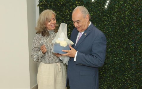 Liliana Reinoso, directora del Comité Central de Padres de Familia, entrega un obsequio a Abelardo García.