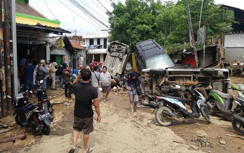 BEKASI. Un corrida de aguas lluvias arrastró varios vehículos en una de las calles esta ciudad aledaña a Yakara.