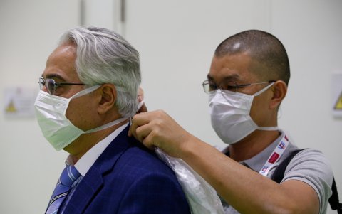 Un hombre ayuda a otro a ajustar una máscara protectora en la Exposición Árabe de Salud 2020 en el emirato del Golfo de Dubai, Emiratos Árabes Unidos.