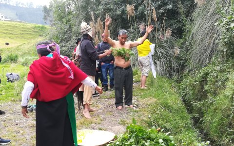 El yachak Tayta Pomaquero lleva a cabo la limpieza del cuerpo con ortiga, para sacar las malas energías antes de recibir el baño en el ritual de purificación.