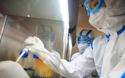 This photo taken on February 19, 2020 shows laboratory technicians testing samples of virus at a laboratory in Hengyang in China