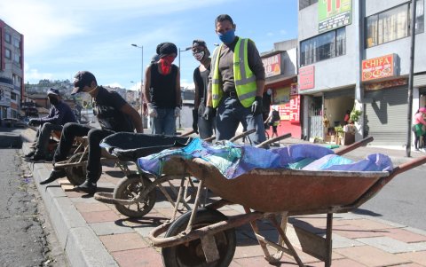 Ante la crisis y el despido masivo de trabajadores, hubo quienes se inventaron oficios para poder subsistir, como estos hombres que, con carretillas llevaban las compras de la gente en los mercados