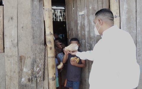 Nicolás Jiménez regala pan en Flor de Bastión a una familia.