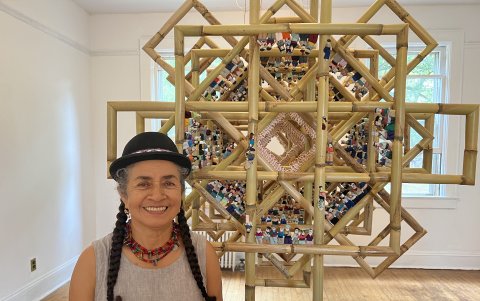 La artista ecuatoriana Carmen Vicente posa junto a su obra 